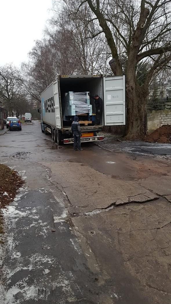 A wrapped machine secured inside a container on a truck